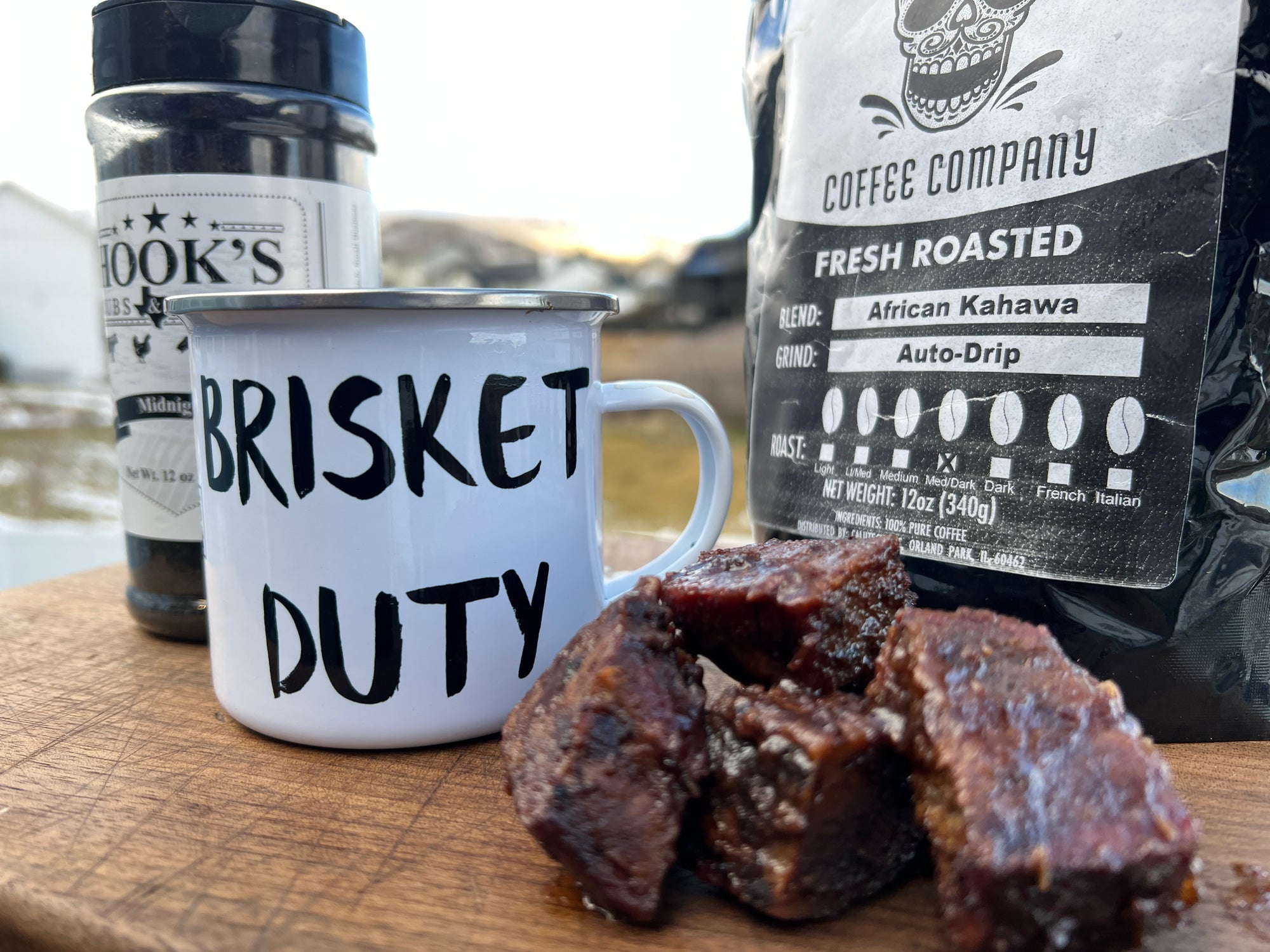 12 oz ‘Brisket Duty’ Enamel Mug by Hook’s Rub – a lightweight, durable, and multifunctional mug perfect for pitmasters during overnight smokes. Ideal for coffee, cocktails, or hot cheesy grits, it features a white coating with a silver rim and measures 3.14″ in height and 3.25″ in diameter. Hand-wash only; not dishwasher or microwave safe breakfast  burnt ends