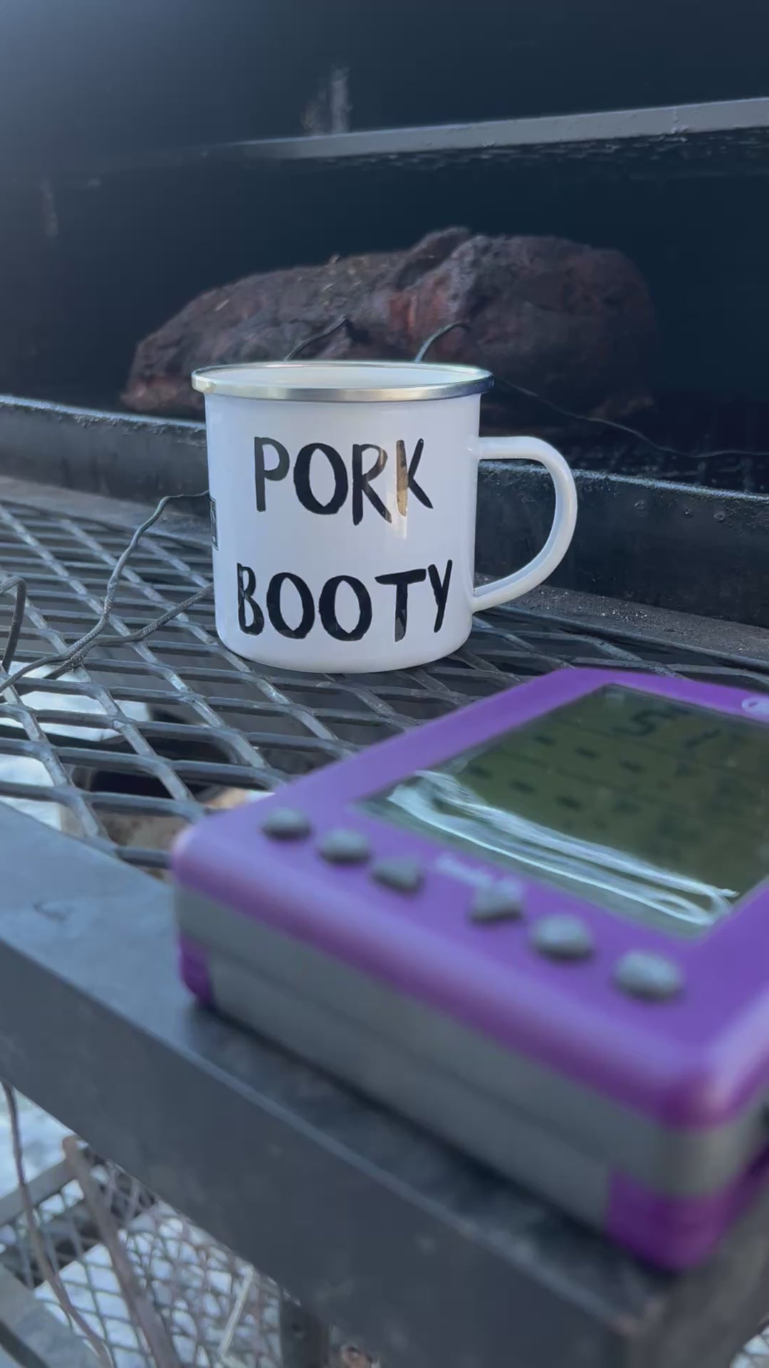 12 oz ‘Pork Booty’ Enamel Mug by Hook’s Rub – a ceramic coffee mug perfect for pulled pork enthusiasts and pitmasters enduring long smokes. Lightweight, durable, and multifunctional, it’s ideal for coffee, cocktails, or hot cheesy grits. Features a white coating with a silver rim, measuring 3.14″ in height and 3.25″ in diameter. Hand-wash only; avoid heating liquids or food directly in the mug to prevent coating damage breakfast pancakes waffles crepes  brisket smoker grill thermoworks smoke thermometer